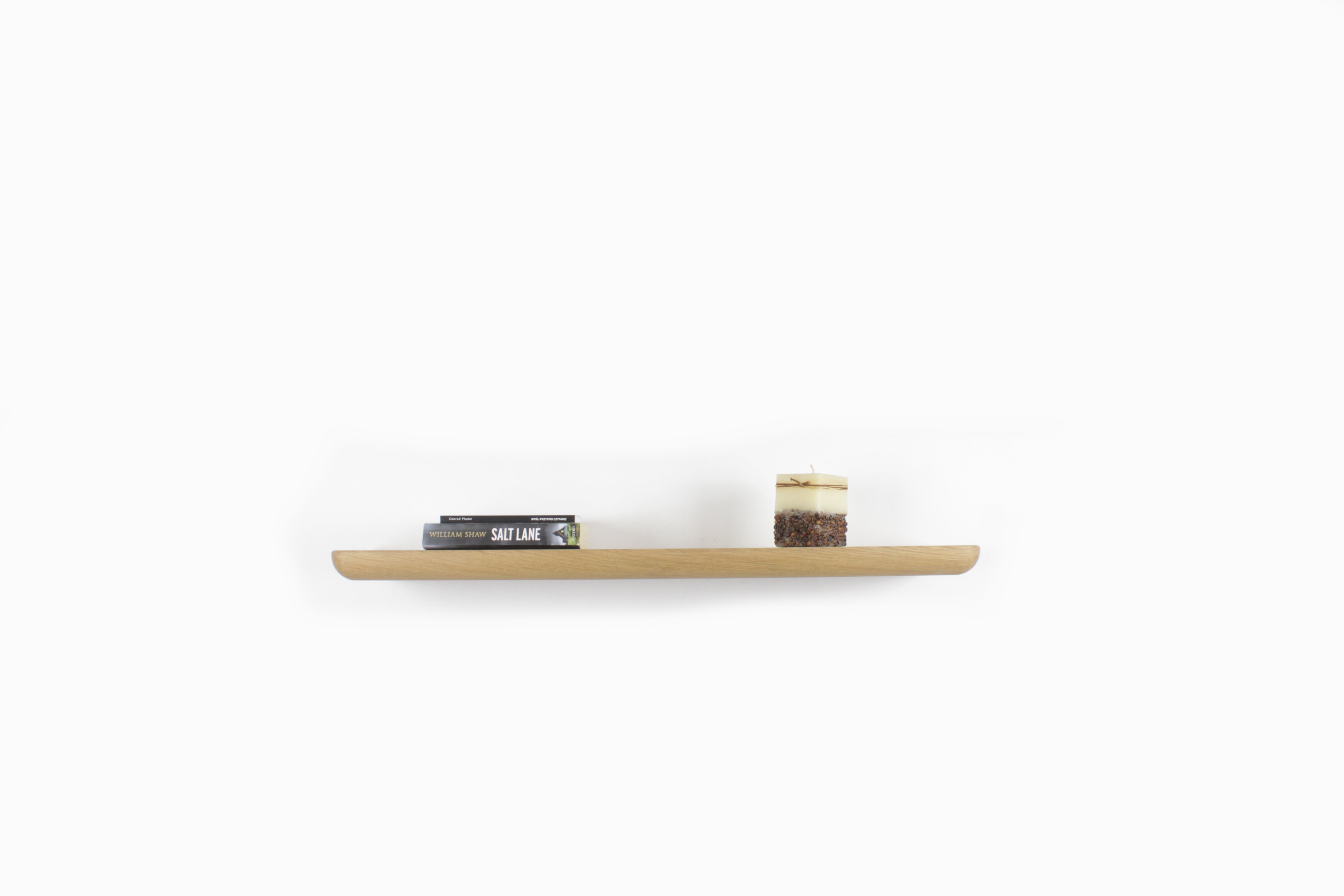 Wall Shelf - Oak: handcrafted floating shelf displaying books and a candle, perfect for modern home decor.