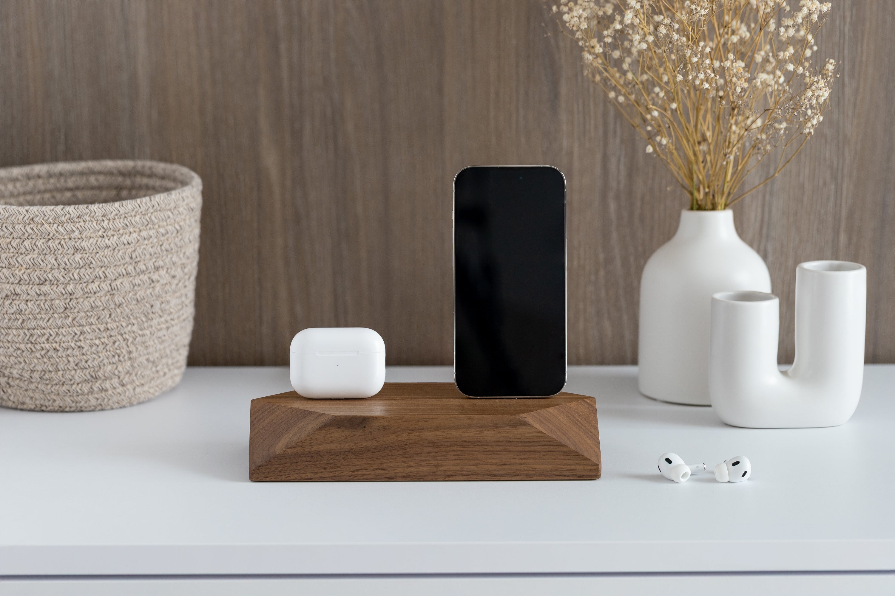 Dual Phone Dock - Walnut on a desk with phone and AirPods, offering convenient device charging.