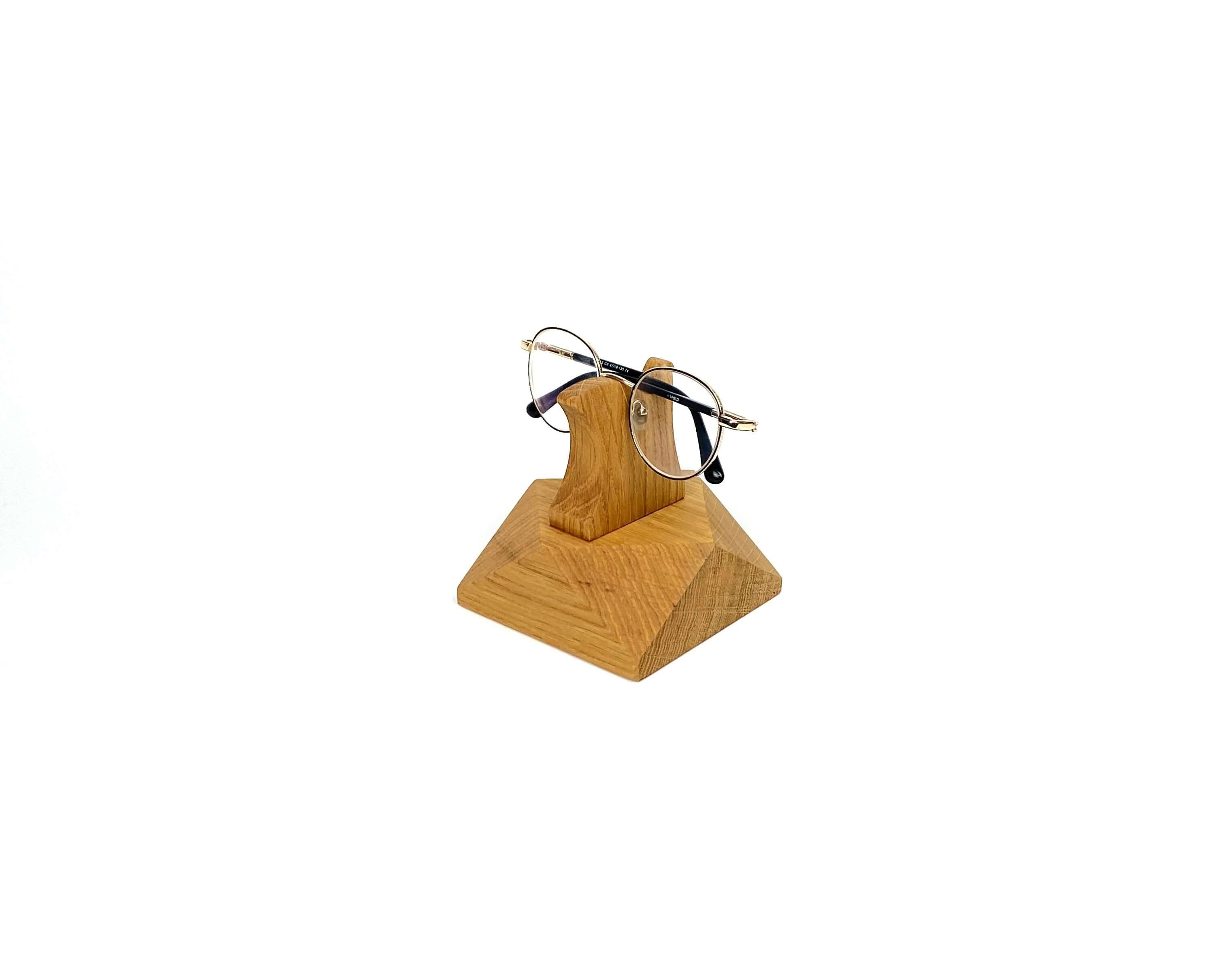 Handcrafted wooden eyeglasses stand holding stylish glasses, perfect for desk or nightstand organization.