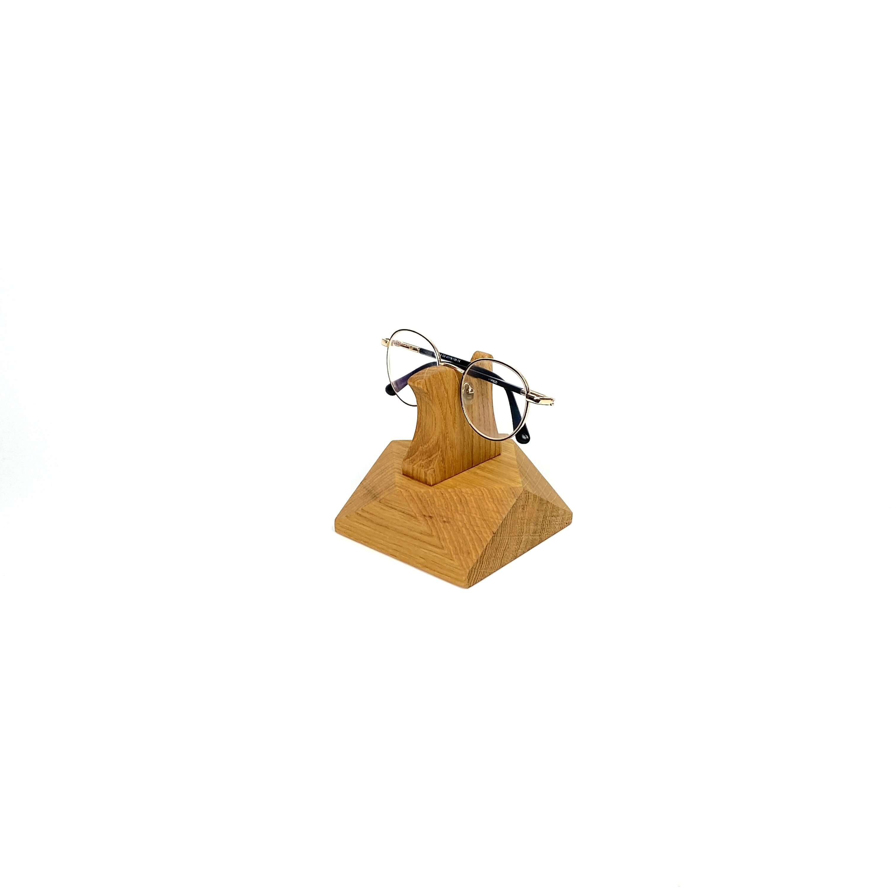 Handcrafted wooden eyeglasses stand holding stylish glasses, perfect for desk or nightstand organization.