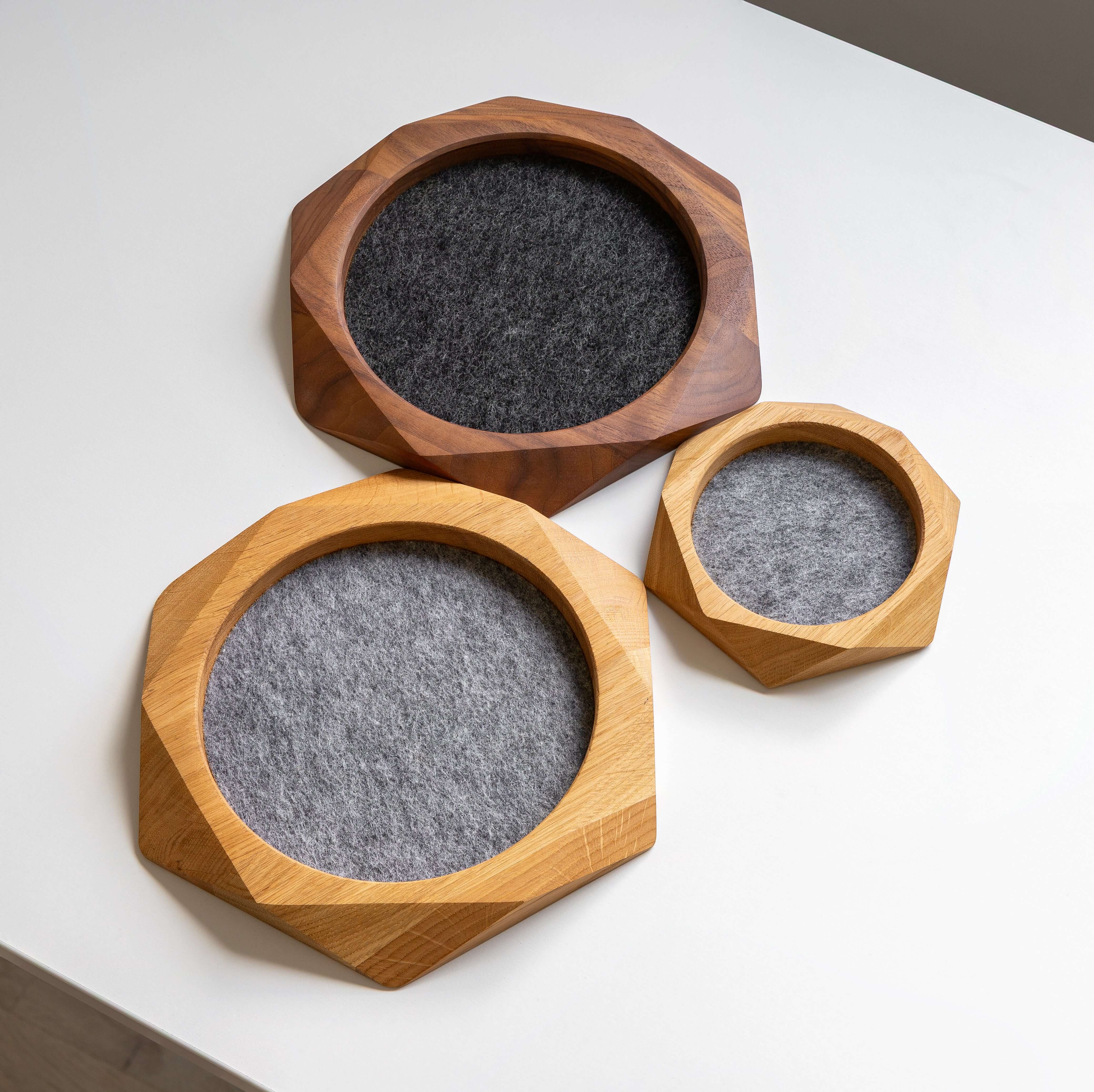 Geometric Wooden Tray set in black oak and natural wood, lined with felt for organizing items.