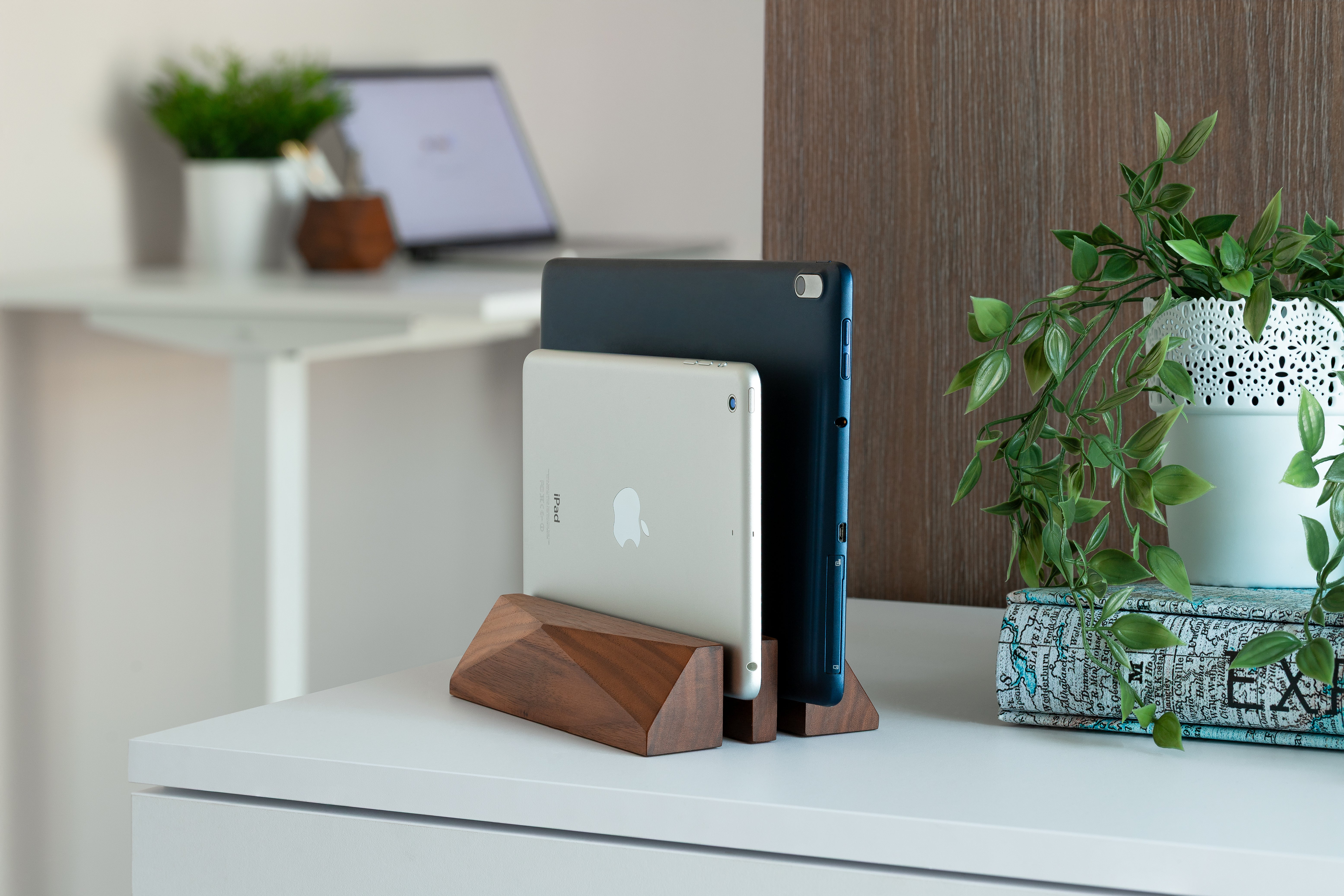 Dual Laptop Dock - Walnut holding two devices in a stylish workspace, showcasing minimalist design and organization.