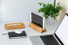 Laptop Dock - Walnut: Stylish vertical dock for laptops and tablets on a clean workspace with wooden accessories.