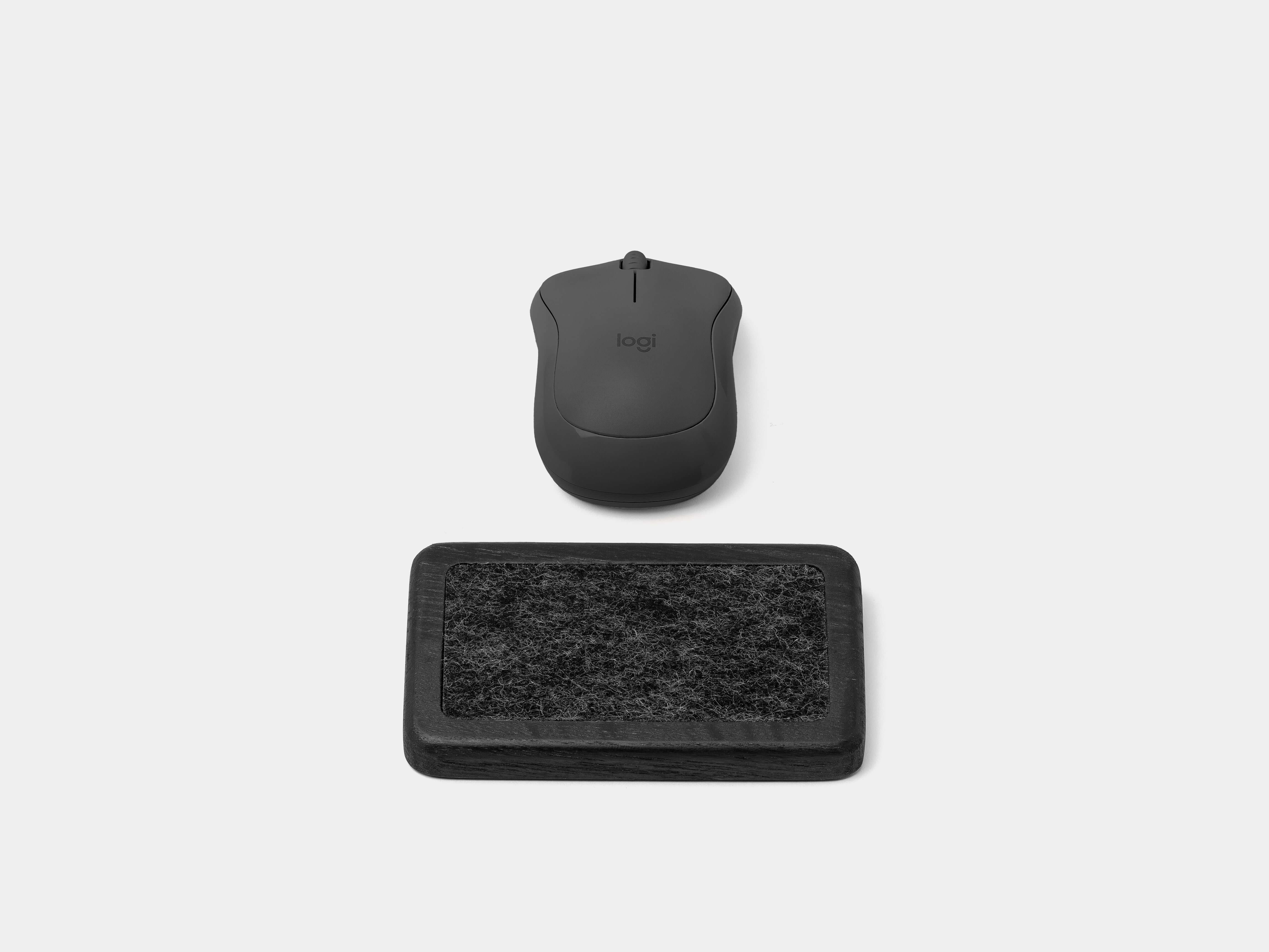 Mouse Wrist Rest - Black Oak with a mouse placed on top for ergonomic workspace comfort.