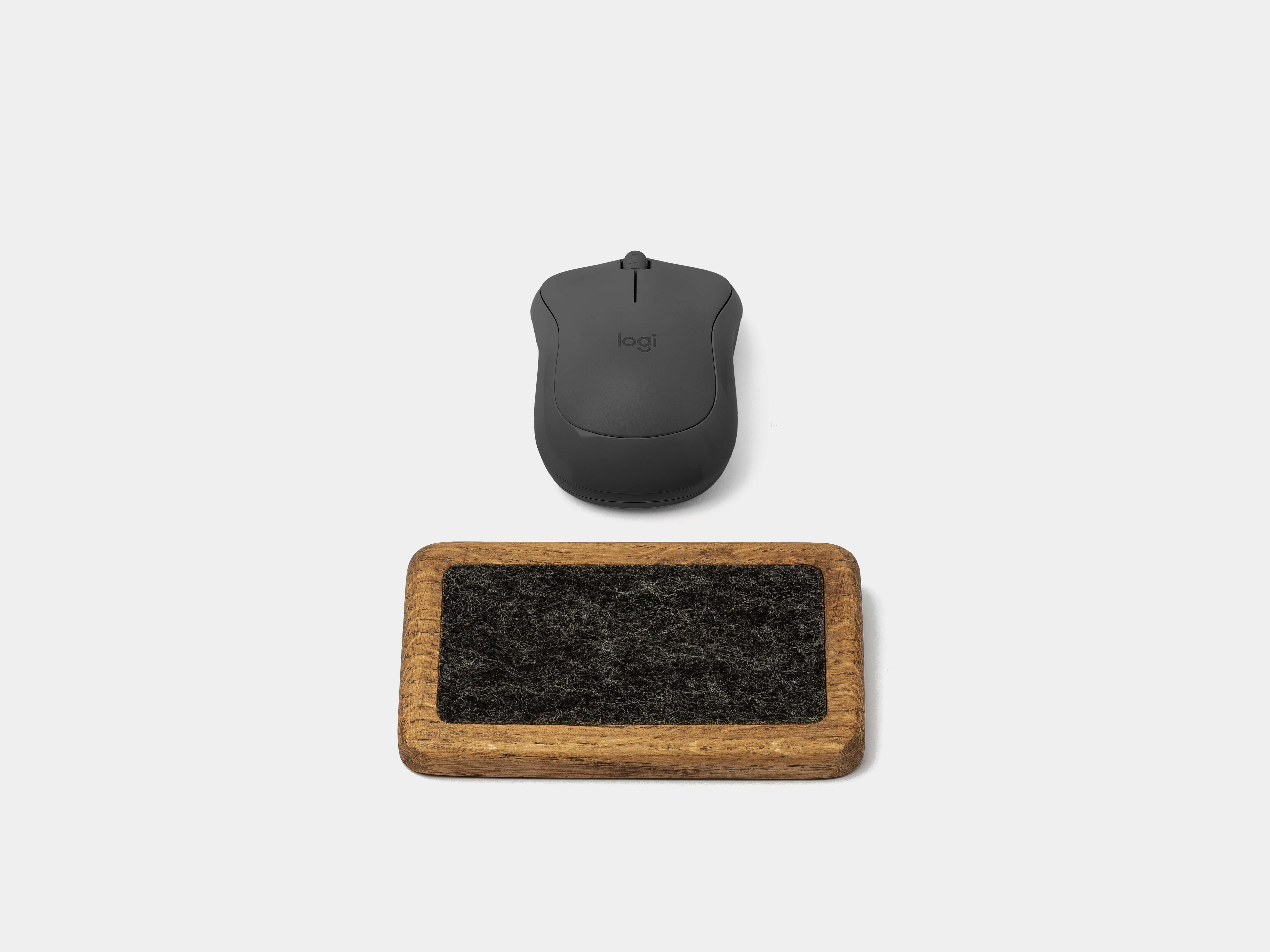 Mouse Wrist Rest - Brown Oak alongside a sleek black wireless mouse on a minimalist background.
