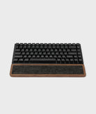 Keyboard Wrist Rest made of walnut wood with black mechanical keyboard on top, providing ergonomic support.
