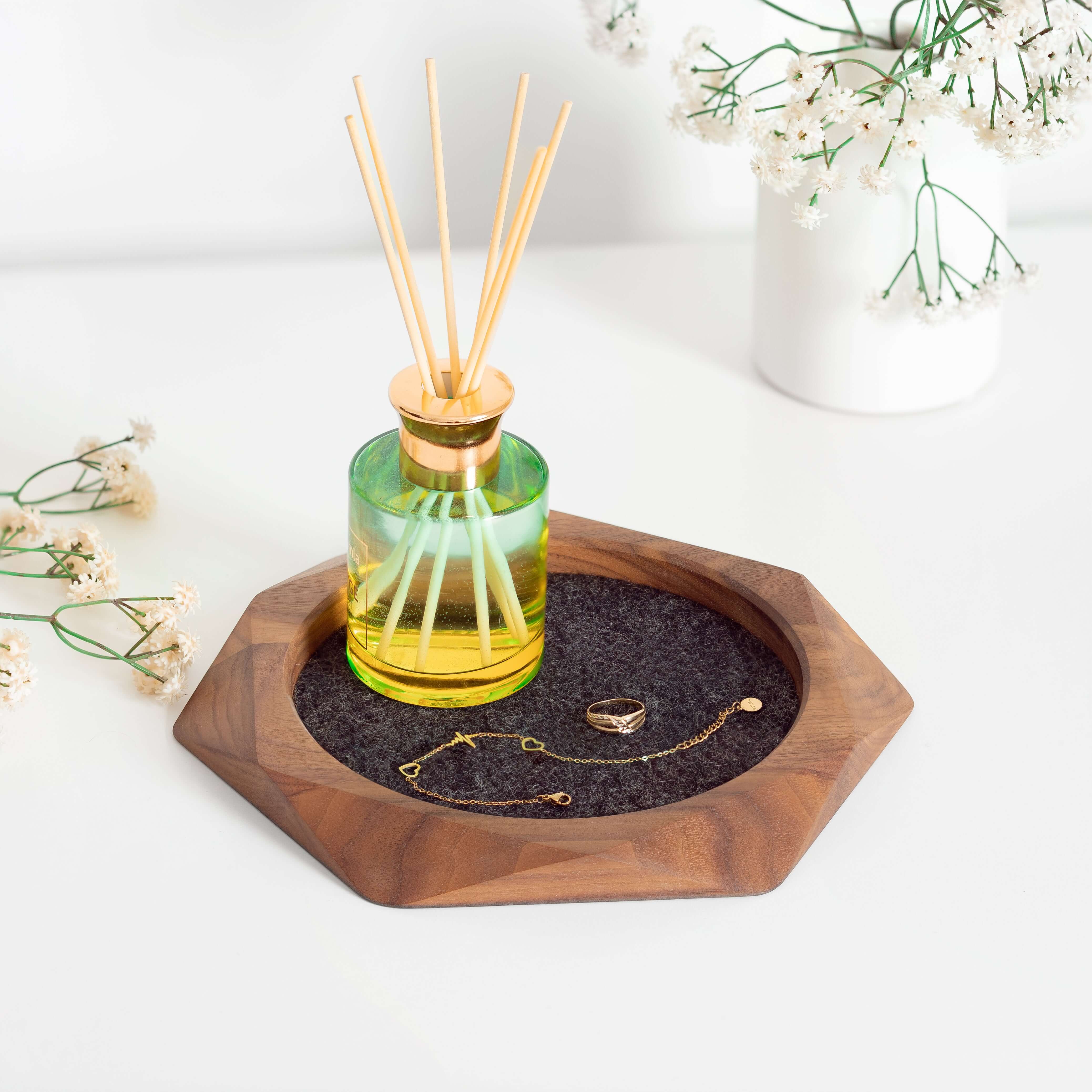 Geometric Wooden Tray made from walnut wood with merino wool felt, used for organizing jewelry and accessories.
